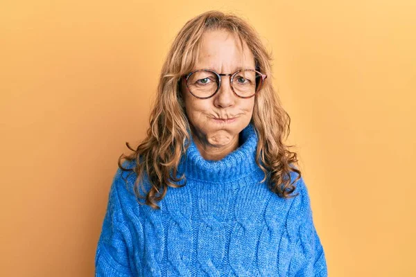 Middle Age Blonde Woman Wearing Glasses Casual Winter Sweater Puffing — Stock Photo, Image