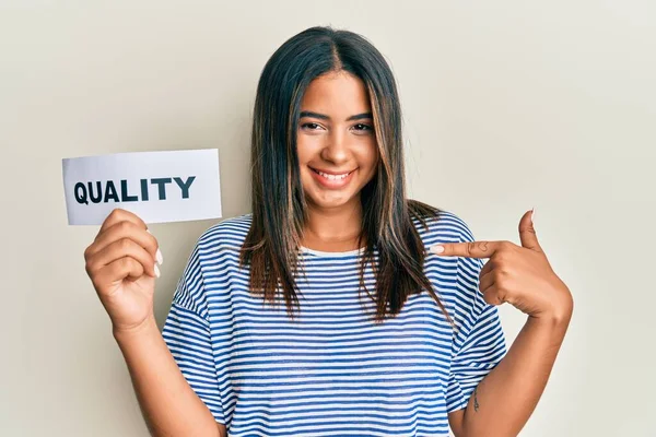 Young Latin Girl Holding Quality Word Paper Pointing Finger One — Stock Photo, Image