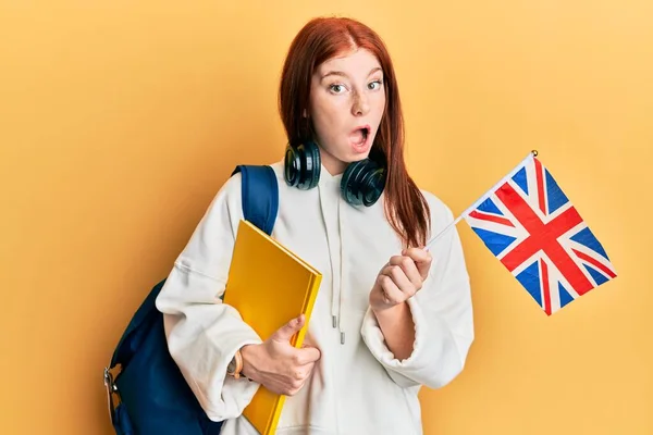 Young Red Head Girl Exchange Student Holding Flag Afraid Shocked — Zdjęcie stockowe
