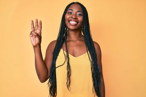 Африканская Американка Косичками Повседневной Одежде Показывает Пальцем Номер Три Улыбаясь — стоковое фото
