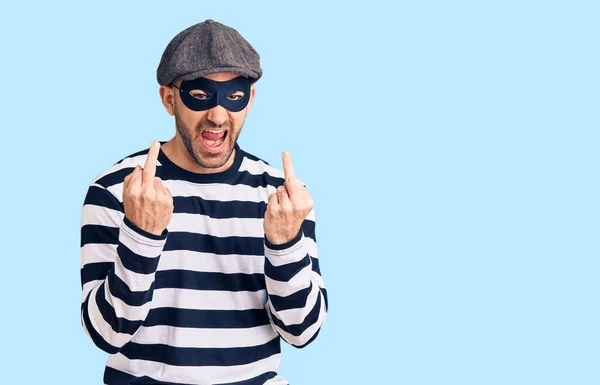 Young Handsome Man Wearing Burglar Mask Showing Middle Finger Doing — 스톡 사진