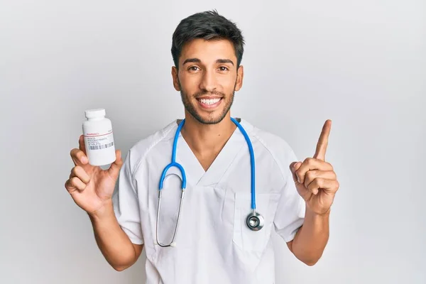 Young Handsome Man Wearing Doctor Uniform Holding Presciption Pills Smiling — Stock Photo, Image