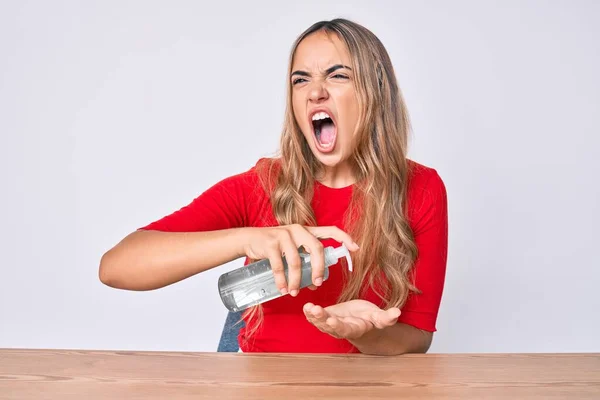 Young Beautiful Blonde Woman Sitting Table Cleaning Hands Using Sanitizer — Stock Photo, Image