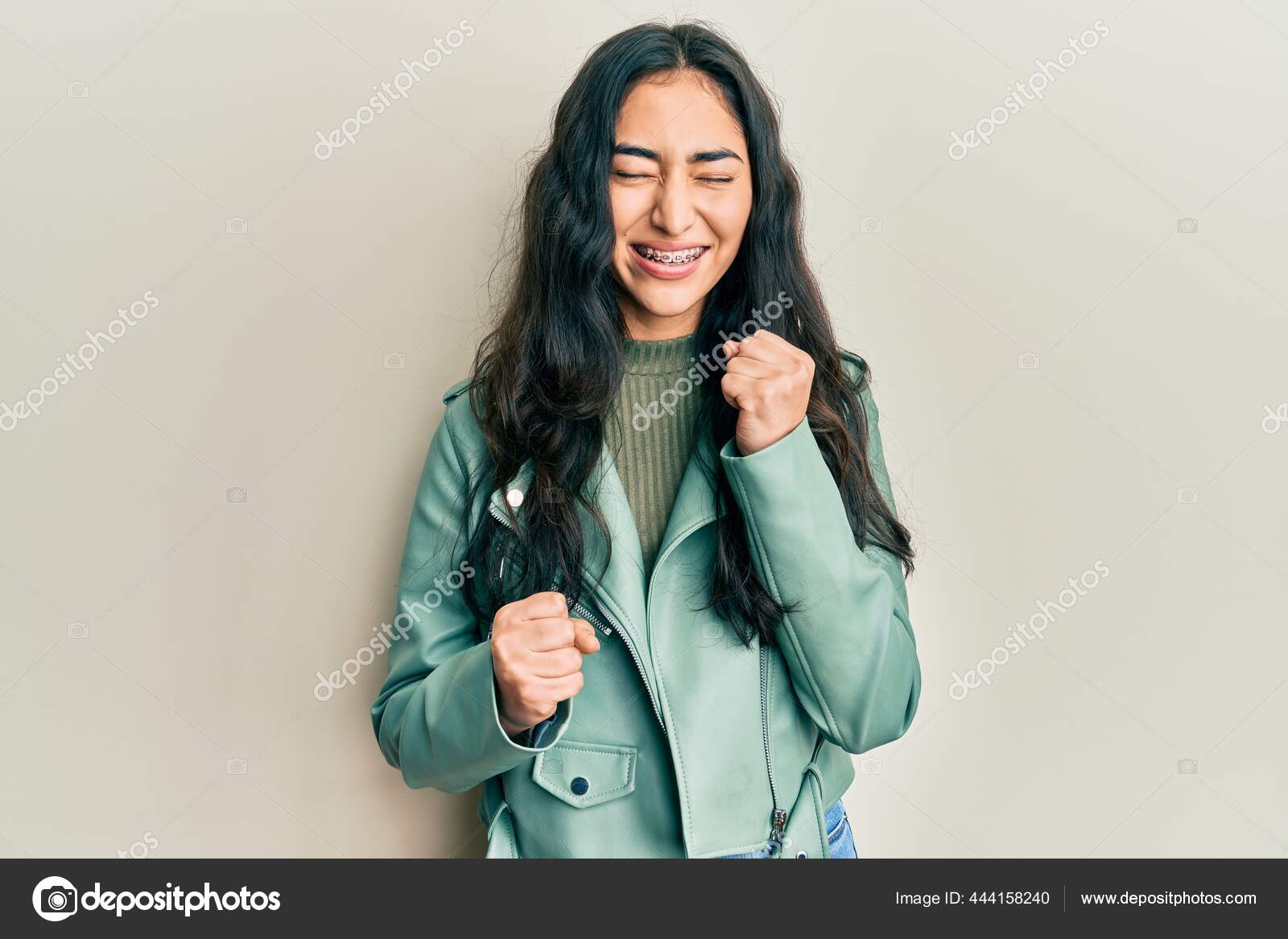 Hispanic Teenager Girl Dental Braces Wearing Green Leather Jacket