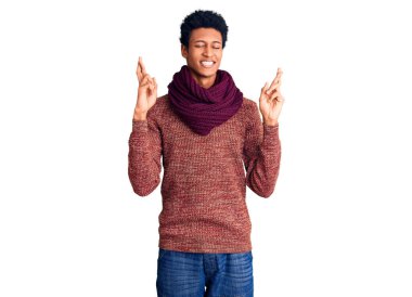 Sıradan bir kazak ve fular takan Afro-Amerikalı genç adam umut ve gözler kapalı gülümseyerek el sallıyor. Şans ve batıl inançlar. 