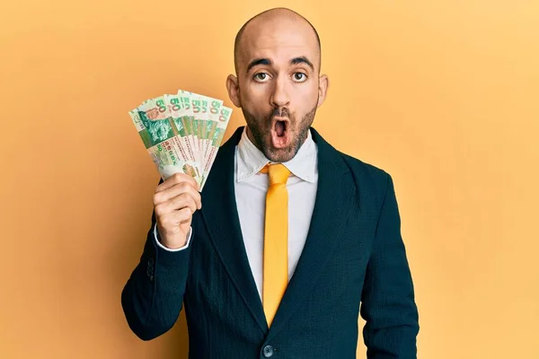 Young Hispanic Business Man Holding Hong Kong Dollars Banknotes Scared — Stock Photo, Image