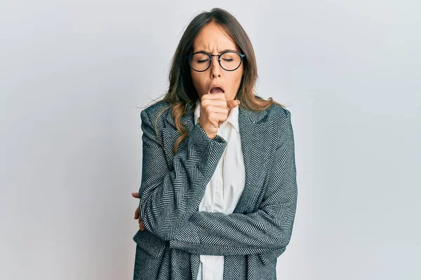 Young brunette woman having conversation talking on the smartphone shocked covering mouth with hands for mistake. secret concept.