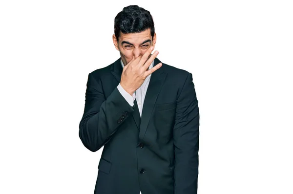 Handsome Hispanic Man Wearing Business Clothes Smelling Something Stinky Disgusting — Stock Photo, Image