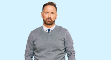 Handsome middle age man wearing business clothes depressed and worry for distress, crying angry and afraid. sad expression. 