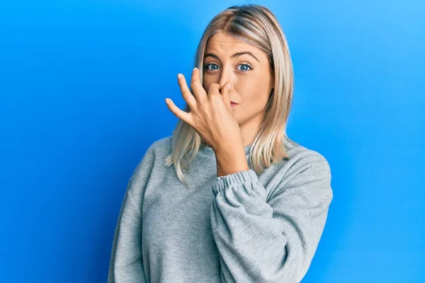 Beautiful Blonde Woman Wearing Casual Clothes Smelling Something Stinky Disgusting — Stock Photo, Image
