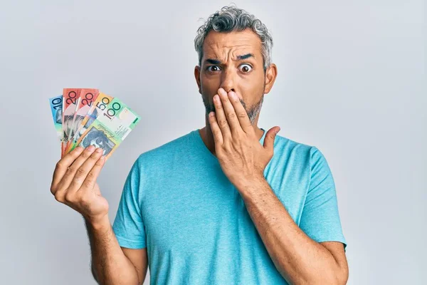 Middle Age Grey Haired Man Holding Australian Dollars Covering Mouth — Stok fotoğraf