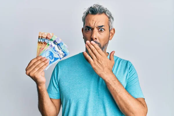 Middle Age Grey Haired Man Holding Canadian Dollars Covering Mouth — Stok fotoğraf