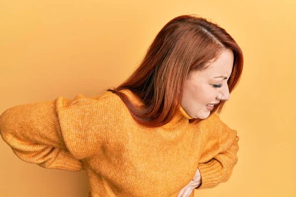 Beautiful Redhead Woman Wearing Casual Winter Sweater Yellow Background Suffering — Stockfoto