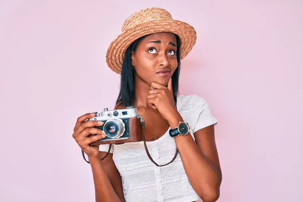 Молода Афроамериканка Одягнена Літню Шапку Тримає Вінтажну Камеру Думаючи Про — стокове фото