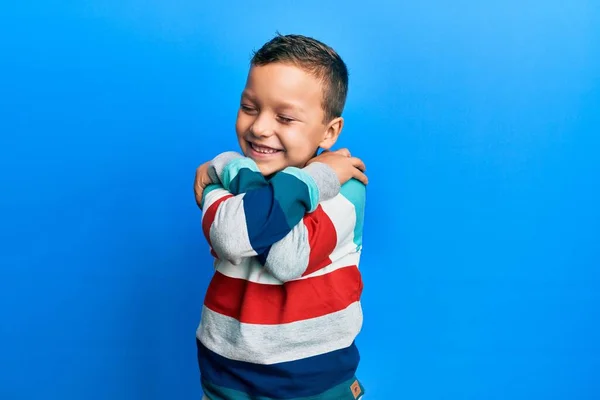 Little Kid Boy Wearing Striped Sweater Hugging Oneself Happy Positive — Stockfoto