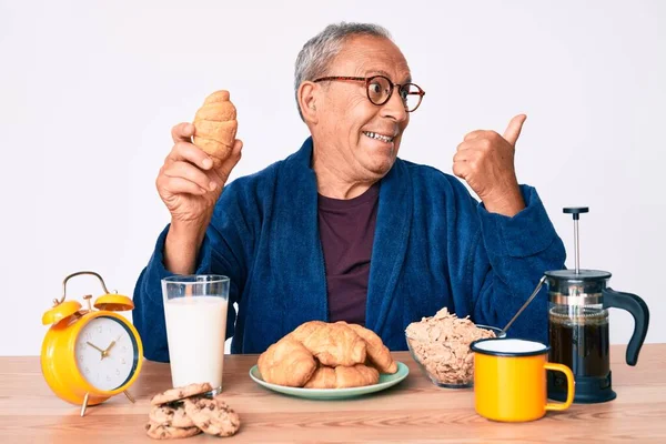 Homem Bonito Sênior Com Cabelos Grisalhos Sentado Mesa Comendo Croissant — Fotografia de Stock