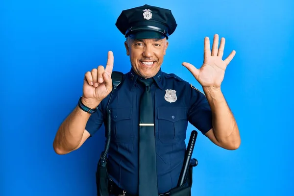 Handsome middle age mature man wearing police uniform showing and pointing up with fingers number six while smiling confident and happy.
