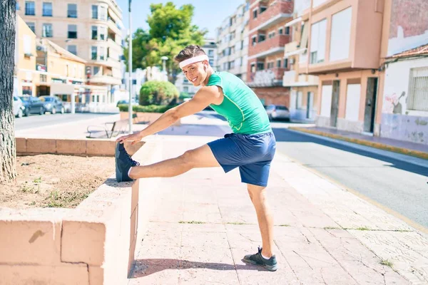 Young Hispanic Sportsman Using Earphones Stretching Street City — Stock Photo, Image