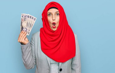İslami tesettürlü güzel İspanyol kadın elinde Japon Yen banknotları tutuyordu. Şaşırmış ve hayrete düşmüştü. 