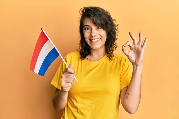 Ung Latinamerikansk Kvinna Håller Holland Flagga Gör Tecken Med Fingrar — Stockfoto