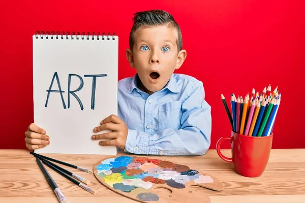 Adorable Pintor Infantil Caucásico Sentado Estudio Arte Sosteniendo Palabra Arte — Foto de Stock