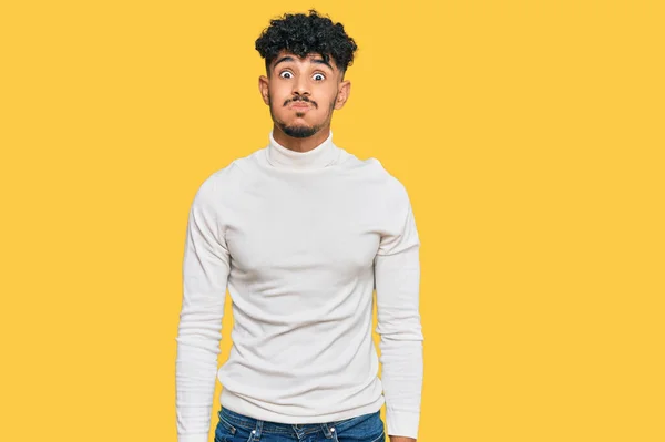 Young Arab Man Wearing Casual Winter Sweater Puffing Cheeks Funny — Stock Photo, Image