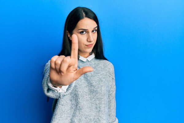 Young hispanic woman wearing casual clothes pointing with finger up and angry expression, showing no gesture 