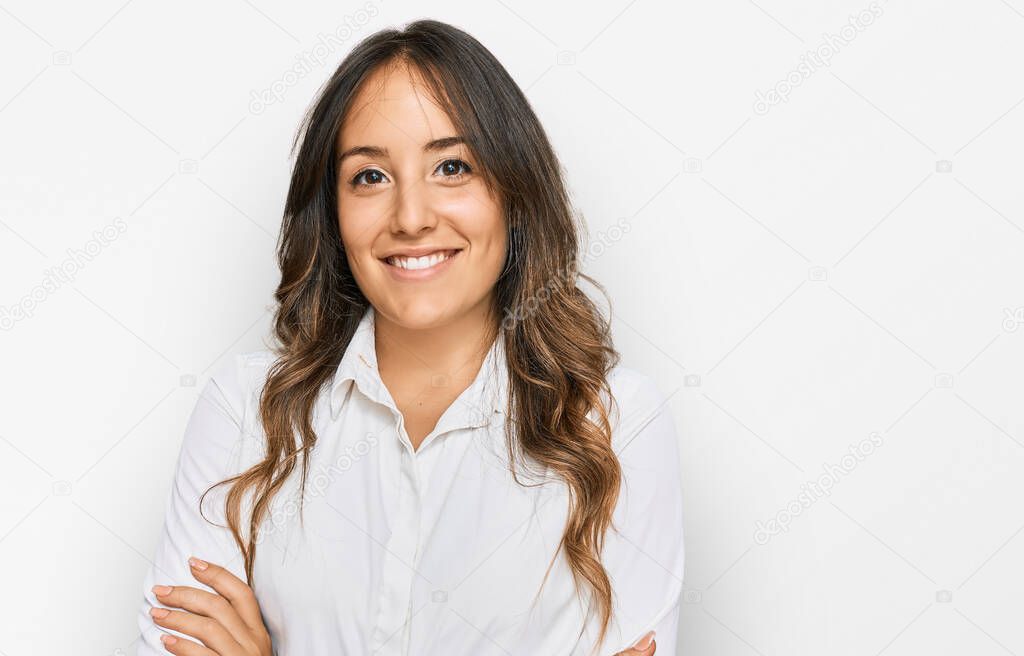 Young brunette woman wearing casual clothes happy face smiling with crossed arms looking at the camera. positive person. 