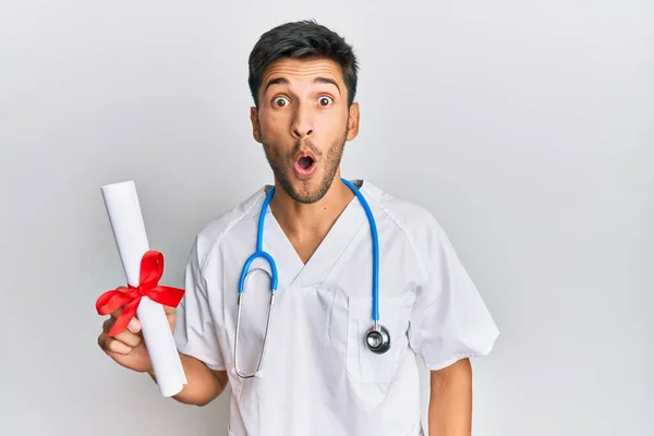 Young Handsome Man Wearing Doctor Uniform Holding Medical Degree Scared — Zdjęcie stockowe