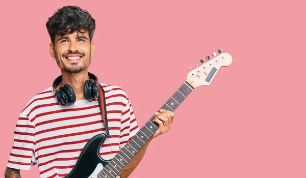 Jovem Hispânico Homem Tocando Guitarra Elétrica Olhando Positivo Feliz Sorrindo — Fotografia de Stock