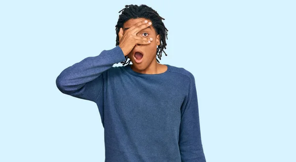 Young African American Man Wearing Casual Winter Sweater Peeking Shock — Stock Photo, Image