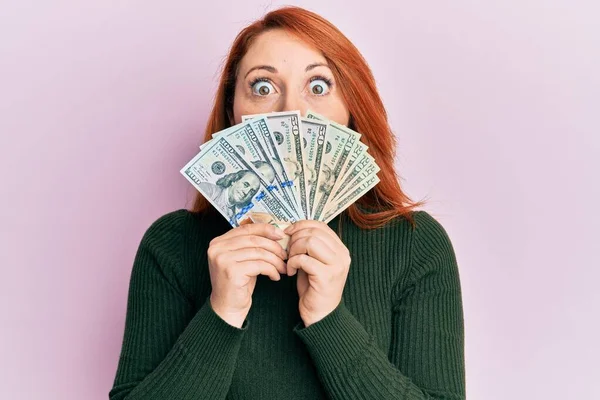 Beautiful Redhead Woman Holding Dollars Close Face Afraid Shocked Surprise — 스톡 사진