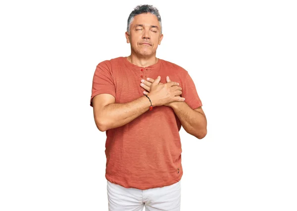 stock image Handsome middle age man wearing casual clothes smiling with hands on chest with closed eyes and grateful gesture on face. health concept. 