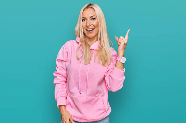 Young Blonde Woman Wearing Casual Sweatshirt Big Smile Face Pointing — Stockfoto