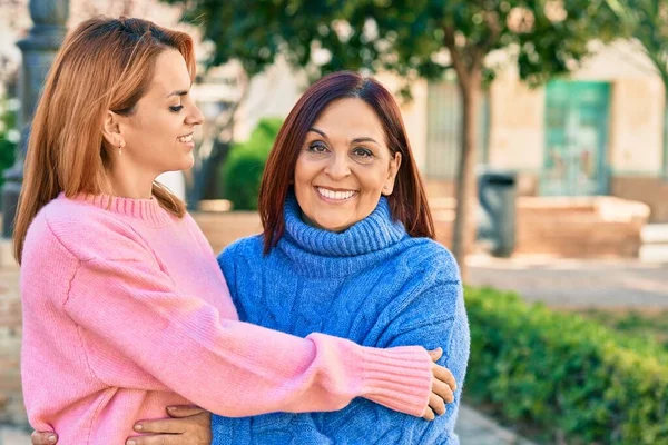 西班牙裔母亲和女儿在公园里高兴地微笑着 拥抱着 — 图库照片