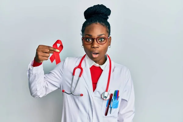 Joven Mujer Afroamericana Vistiendo Uniforme Médico Sosteniendo Apoyo Cinta Roja —  Fotos de Stock