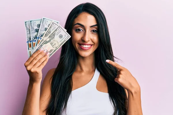 Beautiful Hispanic Woman Holding Dollars Smiling Happy Pointing Hand Finger — Stock Photo, Image