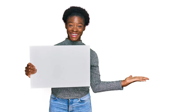 Young African American Girl Holding Blank Empty Banner Celebrating Victory — Stock Photo, Image