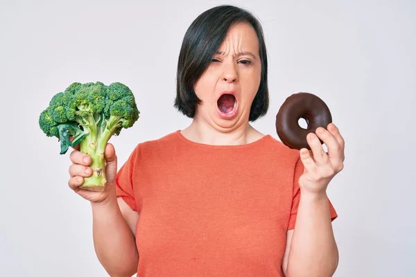 Donna Bruna Con Sindrome Con Broccoli Ciambella Cioccolato Arrabbiata Pazza — Foto Stock