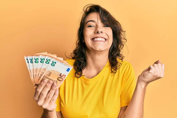 Young Hispanic Woman Holding Bunch Euro Banknotes Screaming Proud Celebrating — Stock Photo, Image