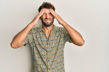 Handsome man with beard wearing casual fashion shirt with hand on head, headache because stress. suffering migraine. 