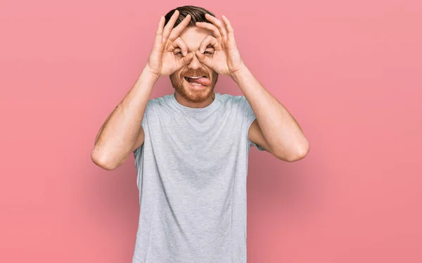 Young Redhead Man Wearing Casual Grey Shirt Doing Gesture Binoculars — 스톡 사진