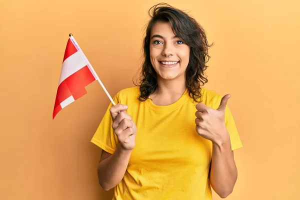 Young Hispanic Woman Holding Austria Flag Smiling Happy Positive Thumb — Foto Stock