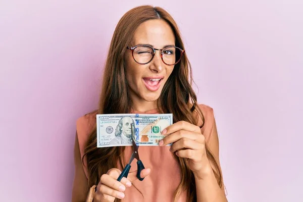 Young Brunette Woman Cutting Dollars Scissors Currency Devaluation Winking Looking — Stockfoto