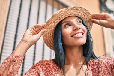 Genç Afro-Amerikan turist kadın tatilde gülümseyerek şehirde mutlu bir şekilde yürüyor..