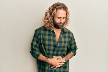 Sakallı, uzun saçlı, eli karnında sıradan kıyafetler giyen yakışıklı bir adam. Çünkü hazımsızlık, acı verici bir hastalık ve kendini iyi hissetmiyor. Ağrı kavramı. 