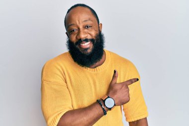 Genç Afro-Amerikalı günlük kıyafetler giymiş neşeli gülümseyen, el ve parmak uçlarında 