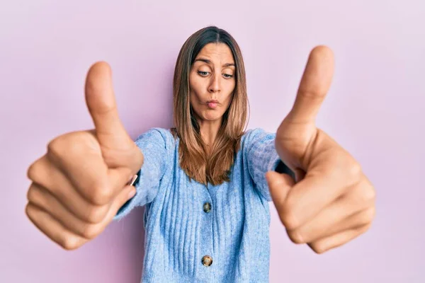 Brunette Young Woman Doing Thumbs Positive Gesture Making Fish Face — Stock Photo, Image