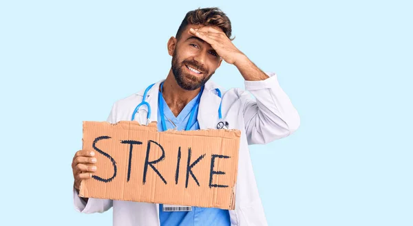 Young Hispanic Man Wearing Doctor Stethoscope Holding Strike Banner Stressed — Stock Photo, Image