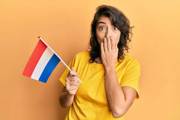 年轻的惊慌失措的女人手拿着荷兰国旗捂着嘴 惊恐万分 生怕犯错 惊讶的表情 — 图库照片